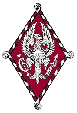 Pi Beta Phi sorority badge featuring a white phoenix or eagle on a crimson diamond shape with a white rope border and the organization's monogram, on a black background.