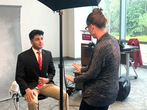 Photographer directing a fraternity member during a composite photo day session. 