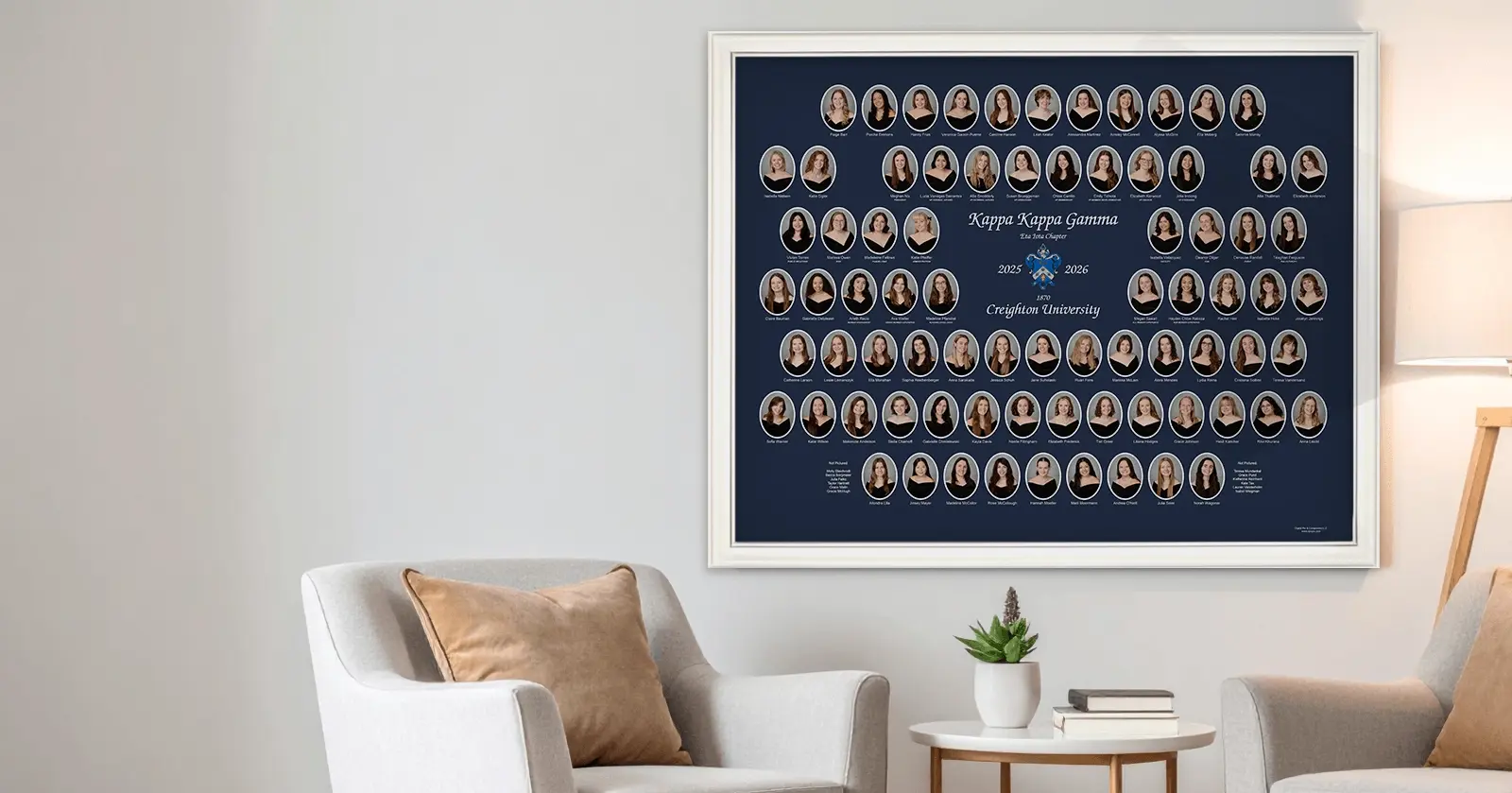 Framed Kappa Kappa Gamma sorority composite for the Eta Iota Chapter at Creighton University, 2025–2026, displayed on a living room wall. The navy blue composite features oval member portraits surrounding the chapter crest in a cream-colored frame.