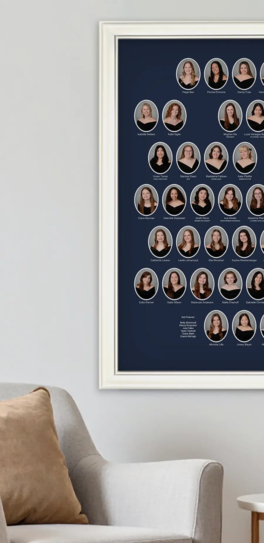 Framed Kappa Kappa Gamma sorority composite for the Eta Iota Chapter at Creighton University, 2025–2026, displayed on a living room wall. The navy blue composite features oval member portraits surrounding the chapter crest in a cream-colored frame.