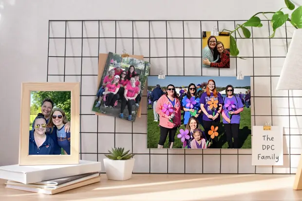 Wire grid board with photos clipped to show various employees at company events and outings. 