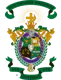 Lambda Chi Alpha fraternity coat of arms featuring a detailed shield with an oil lamp, open book, lion, scales of justice, clasped hands, and stars in green, gold, and purple, topped by a knight's helmet, crown, cross, and crescent, flanked by swords and laurel branches, with green banners
