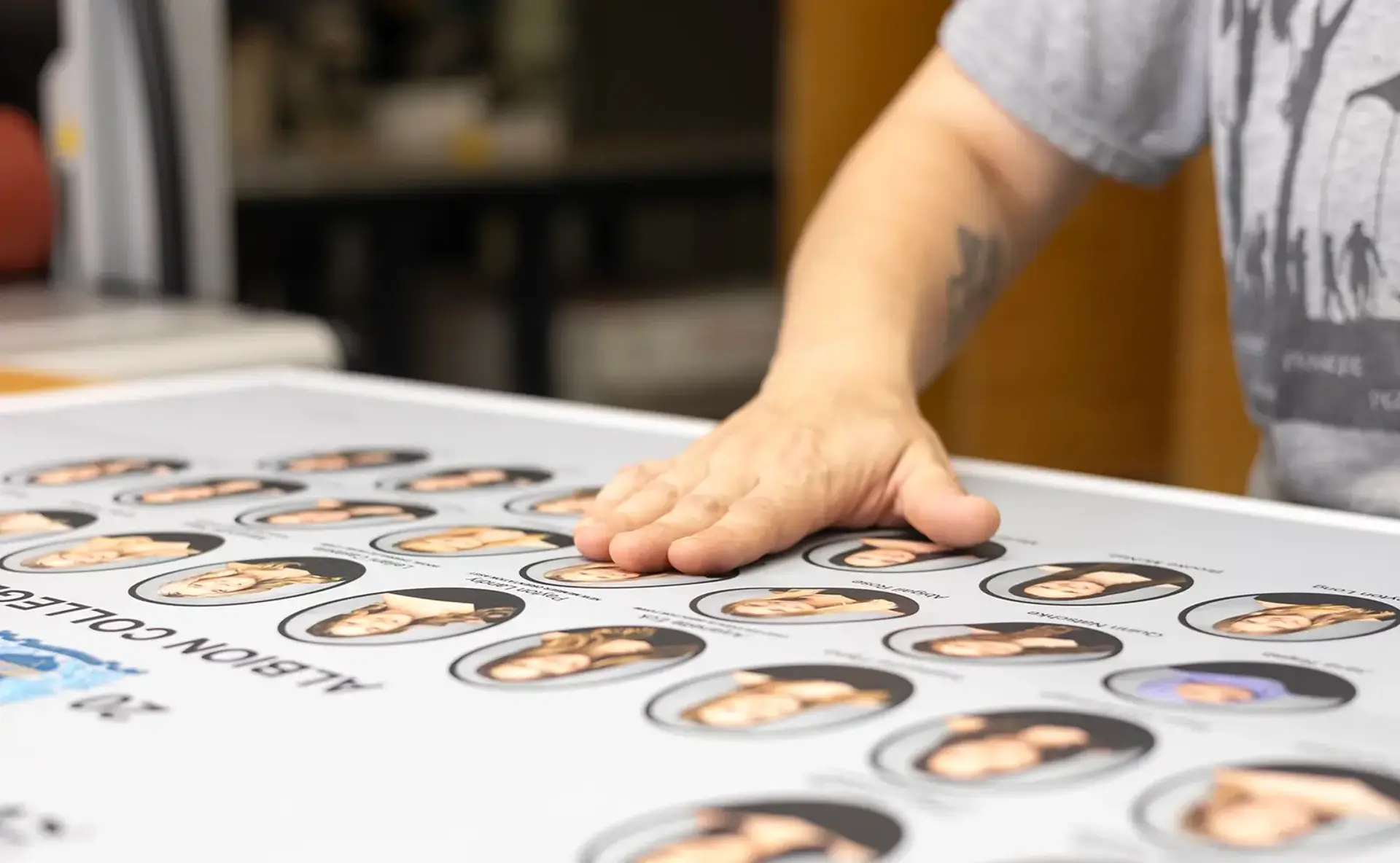 A Digital Pix team member inspecting a finished composite print by hand at the McHenry, Illinois production facility. 